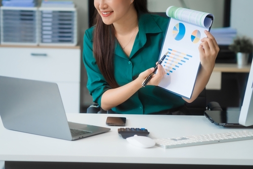 Woman presenting data on laptop during a virtual meeting about family law marketing strategies.