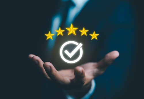 EverConvert marketing professional holding a 5-star review graphic showcasing successful local SEO and reputation management results for improved business visibility.