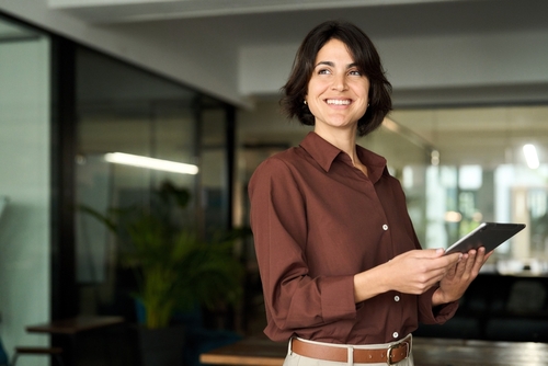 Woman at a marketing agency developing trade services marketing strategies for roofing and landscape businesses.