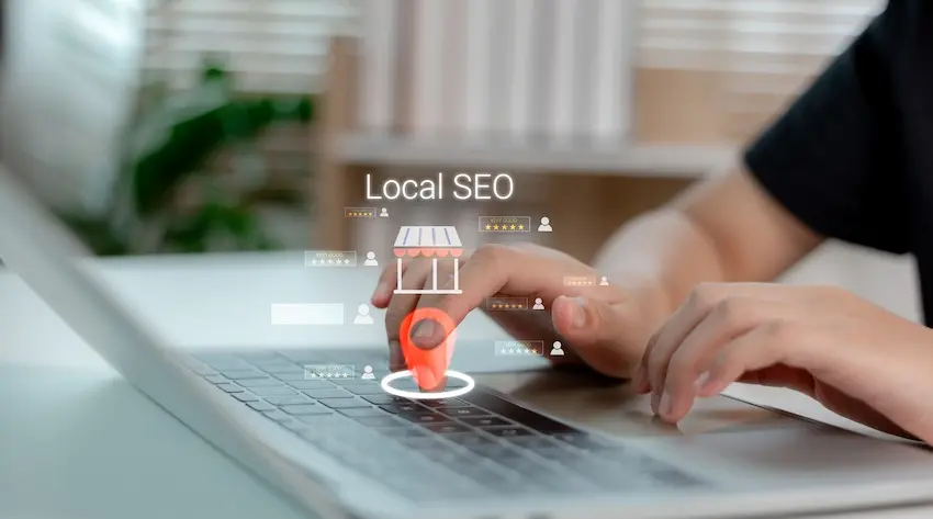 A business professional at EverConvert is using a laptop with digital local SEO overlay showing map pin and storefront icons for geographic targeting.