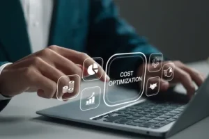 A businessman on his laptop and the words cost optimization appearing on the screen illustrating the importance of the cpc of your law firm ads.