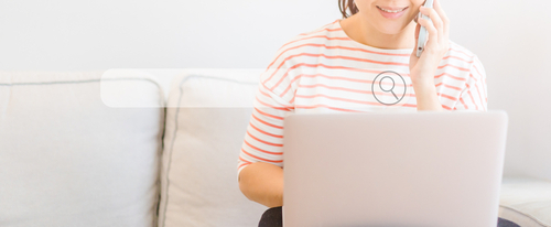 A woman calling a healthcare provider after finding a clinic on her laptop to represent how healthcare SEO services can provide leads.