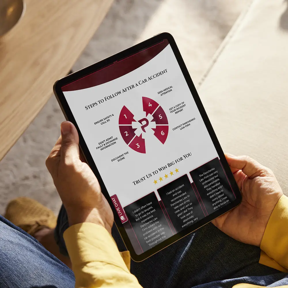 Person holding a tablet with the Panchenko Law Firm website on it.