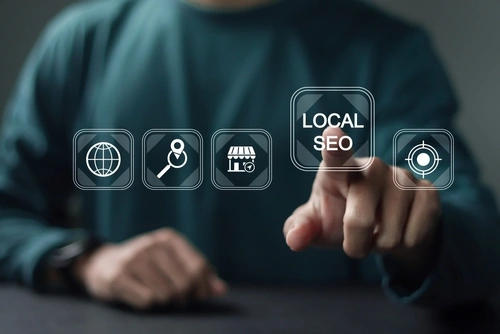 A person tapping on a local seo square as if it is an app on a screen.