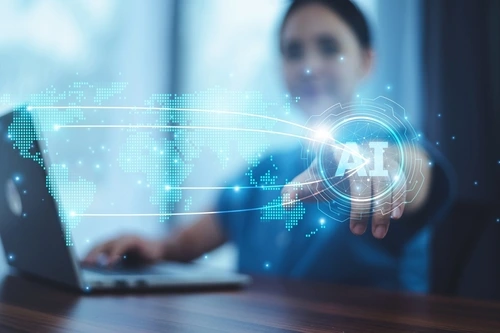 A woman on her computer while AI is showing to represent AI optimization for law firms.