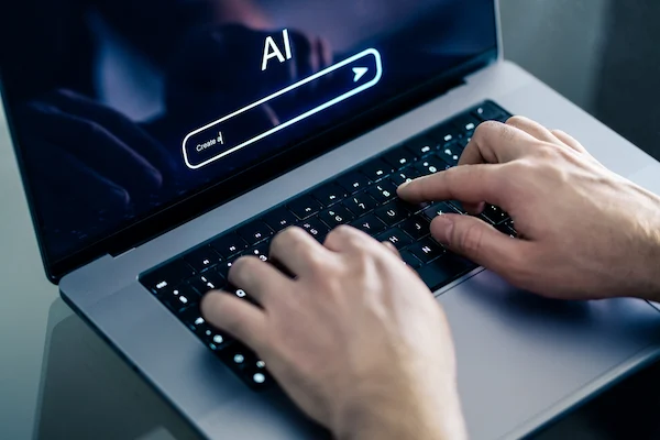 An AI chat prompt on a laptop represents ChatGPT and Google AI overviews.